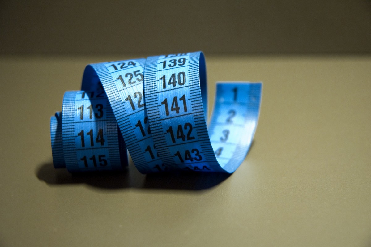 A coiled up blue fabric tape measure
