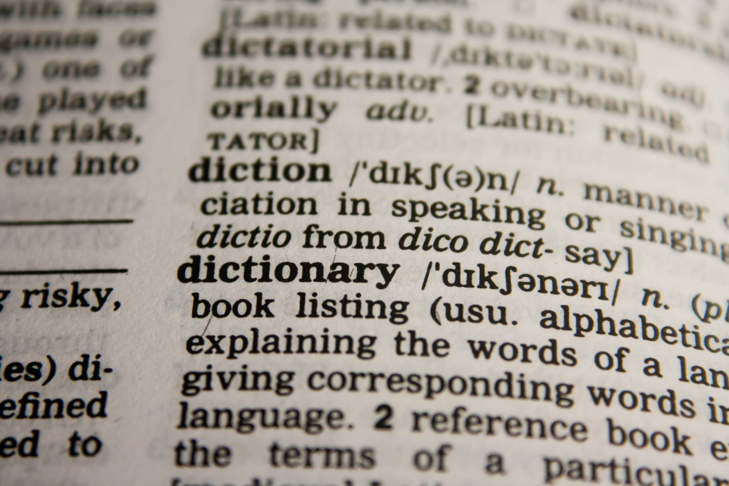 A close up of a page of a dictionary showing the definition of the word "dictionary"